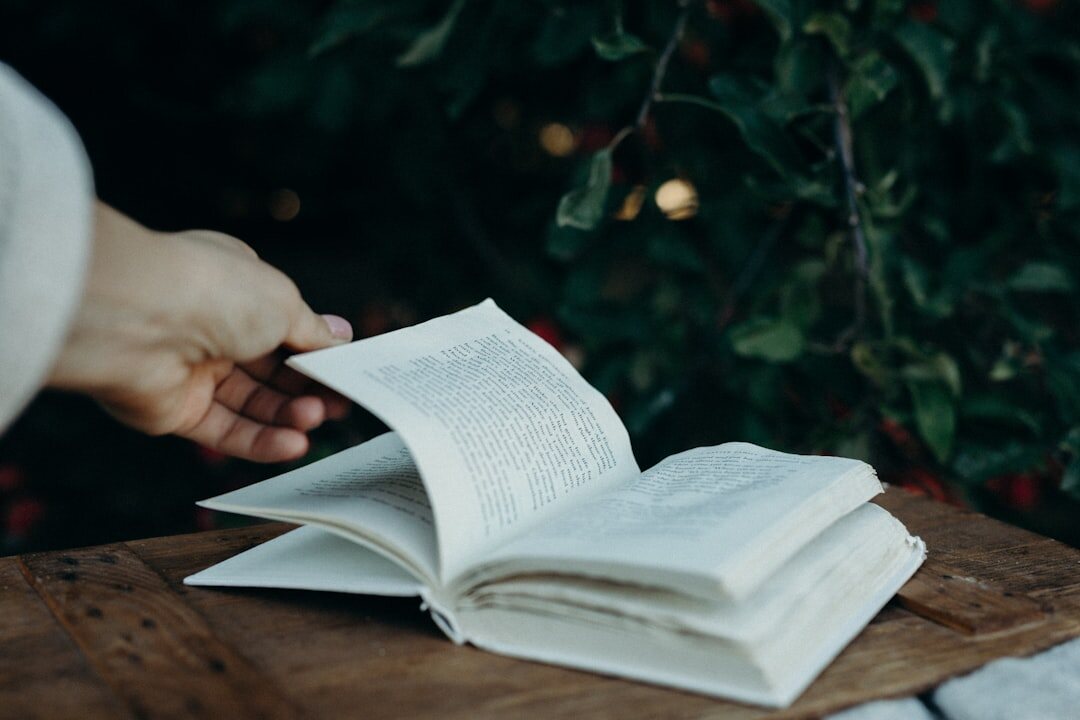 senior reading book in garden